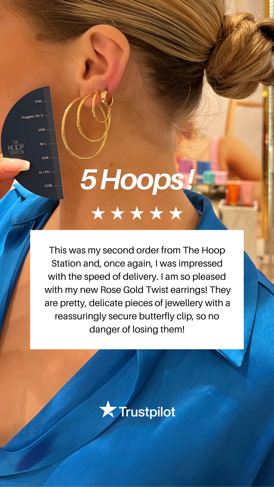Person wearing gold hoop earrings with a product review overlay on a white background